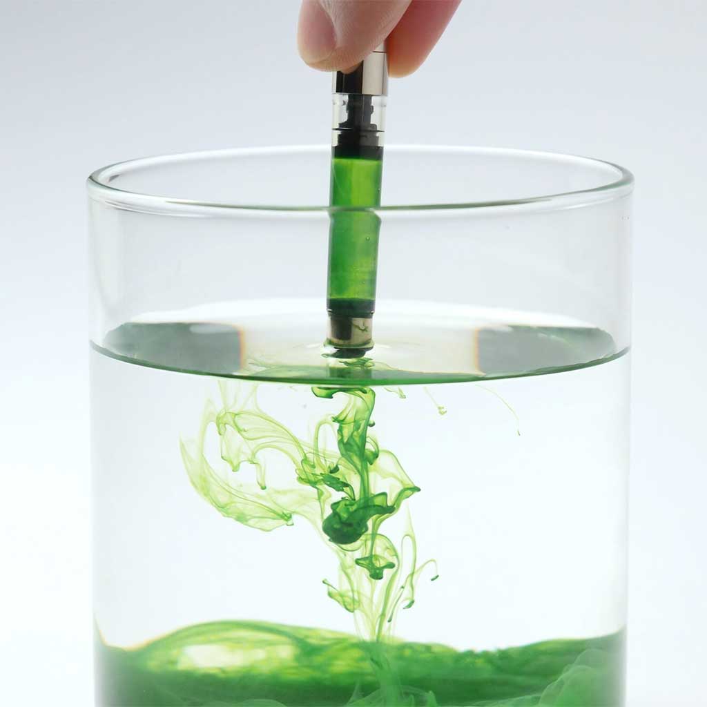 Ink converter being cleaned using glass of ink cleaning solution