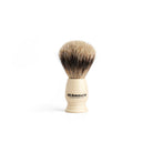 Shaving brush with imitation ivory handle and badger hair on a white background