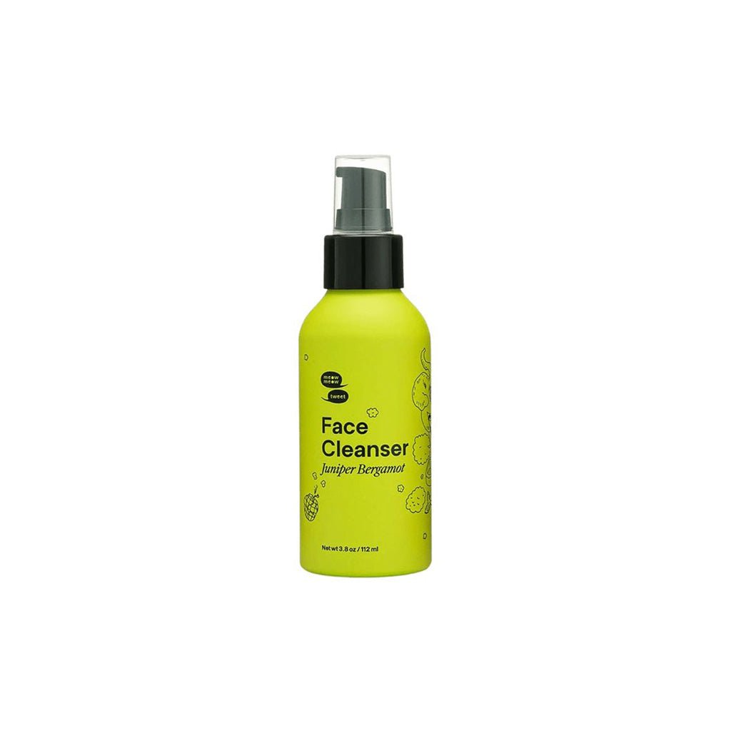 Yellow bottle of face cleanser with black pump cap on a white background