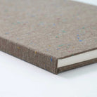 Close-up of a textured brown book on a white background