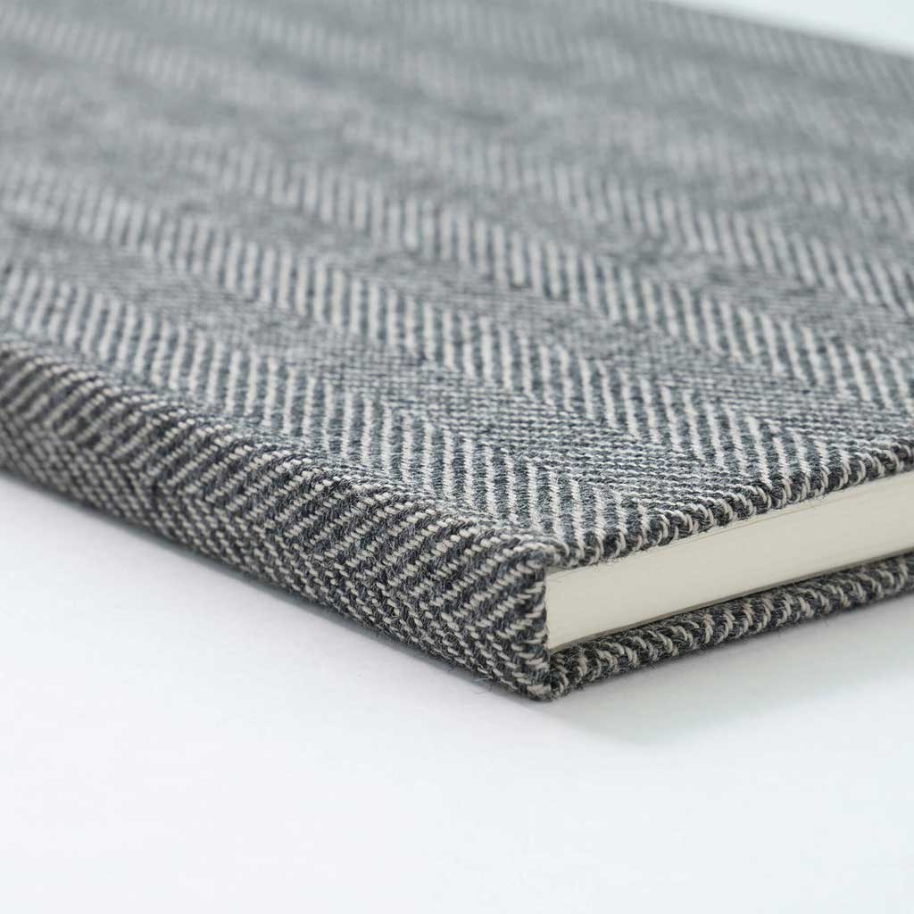 Close-up of a textured gray notebook on a white background