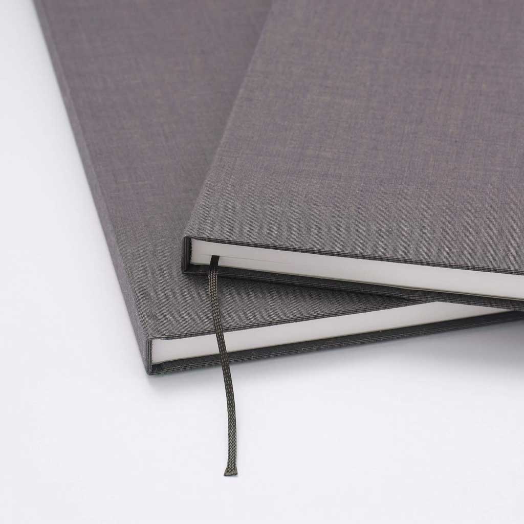 Gray textured notebook with a bookmark on a white background