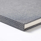 Textured gray A5 notebook on a white background