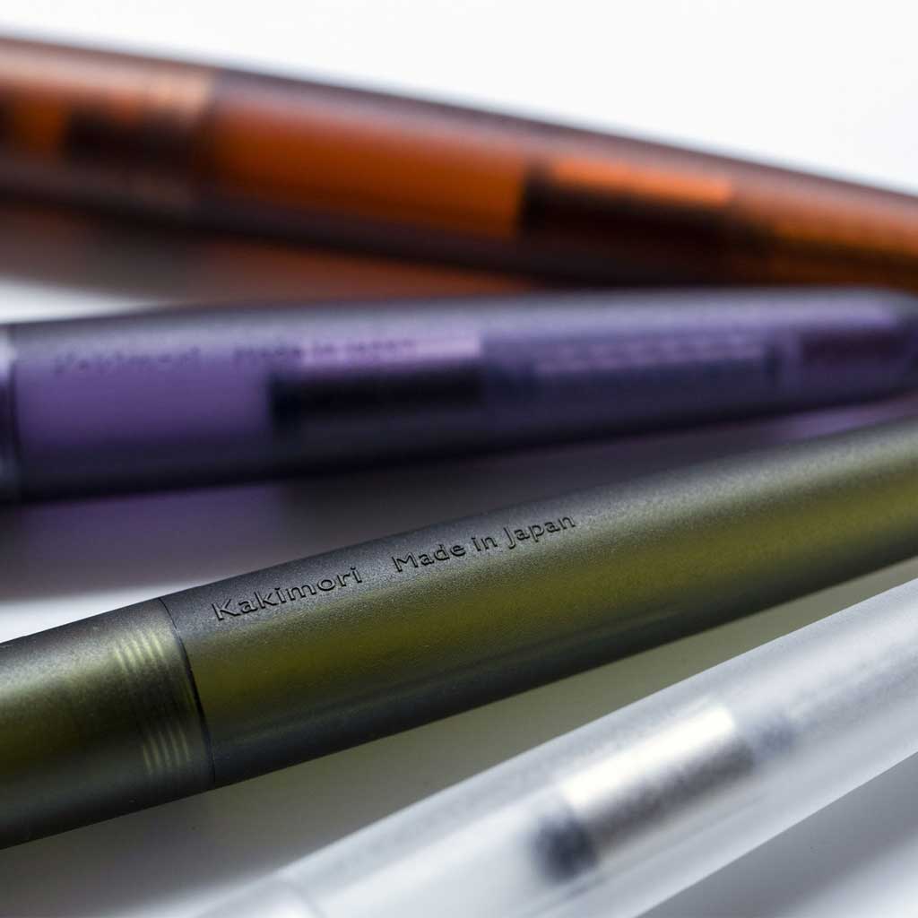 Four pens with visible branding on a light background