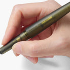 Hand holding a pen with Kakimori branding and 'Made in Japan' inscription on a white background