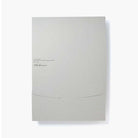 Light gray envelope with a brand name on a white background