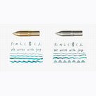 Side by side comparison of Kakimori brass and stainless steel pen nibs with writing examples on gridded paper background