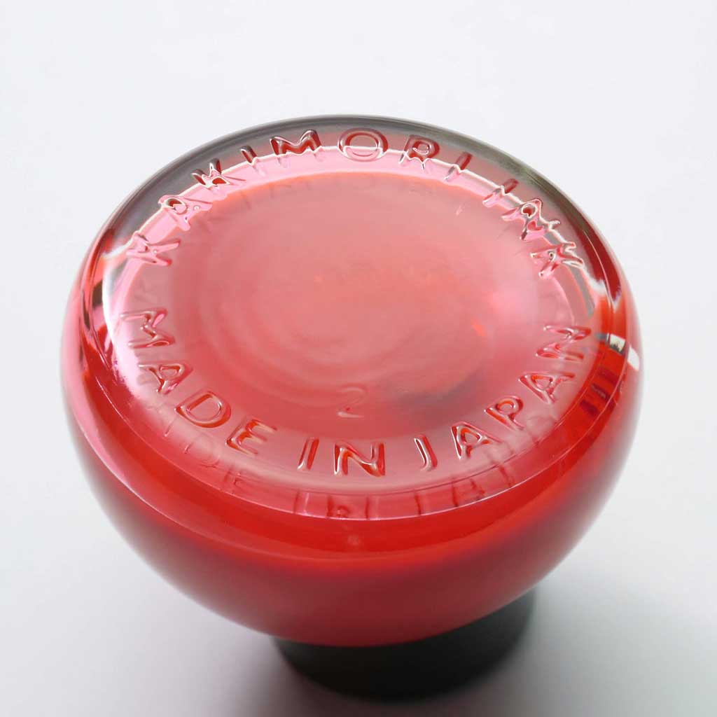 Bottom of glass bottle of red ink with Kakimori Made in Japan inscription
