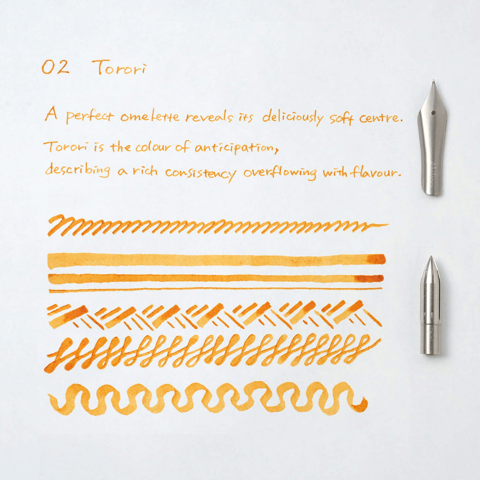 Yellow ink swatches on a white background with two pen nibs.