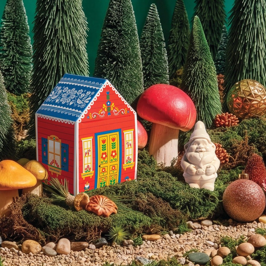 A holiday forest scene with gnome soap, cottage box, and mushrooms.