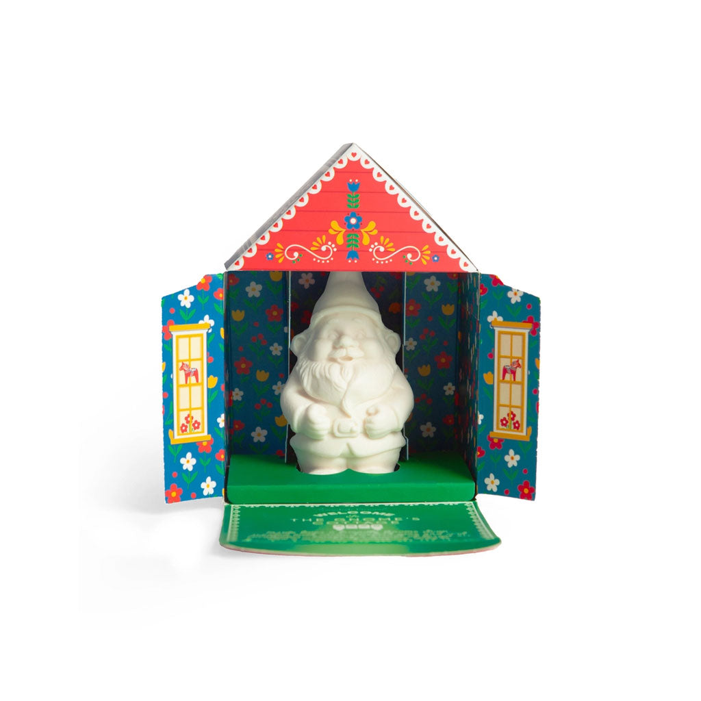 Decorative cottage box open with gnome-shaped soap bar inside.
