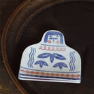 A hand-painted ceramic dish sitting on a wooden plate.