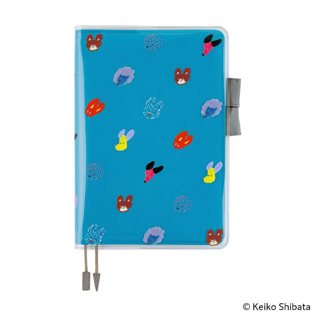 Clear cover on cover with colorful dog illustrations on top of blue fabric cover for Hobonichi Techo A5 Cousin planner on white background