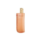 Folding knife inside beige leather knife sheath with red stitching and Niwaki branding on white background