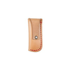 Beige leather knife sheath with red stitching on white background