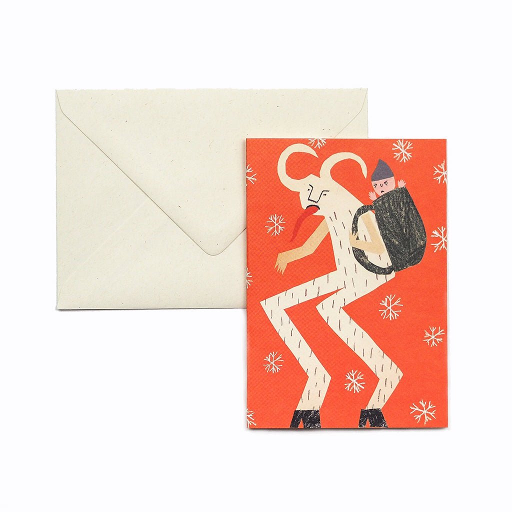 Greeting card with illustration of a child on Krampus' back and an envelope on a white background