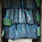 Pile of blue coated steel knife blades in factory