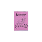 Pink box of a shampoo bar with cartoon cats on a bicycle design.