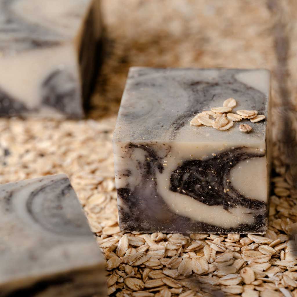 SallyeAnder lavender moon Marble-patterned soap bar with oats on a bed of oats
