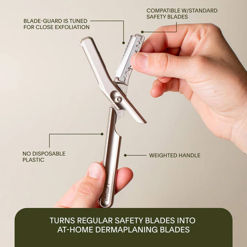 Hand holding a dermaplaning tool with features highlighted on a beige background