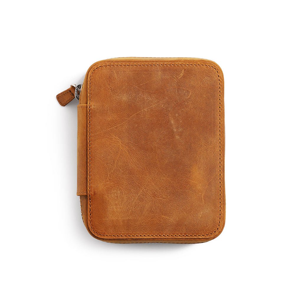 Crazy horse brown leather zippered pen pouch on a white background