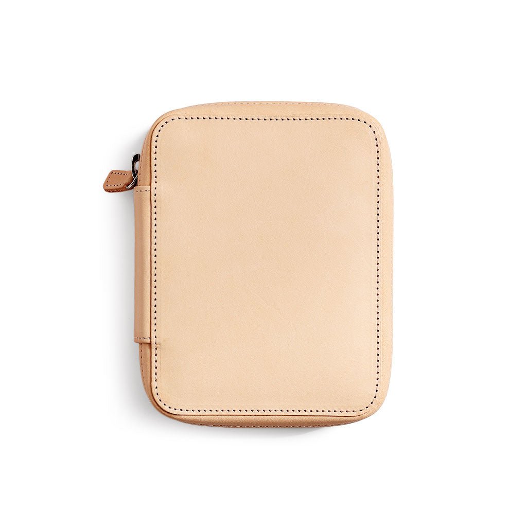 Natural undyed leather zippered pen pouch on a white background