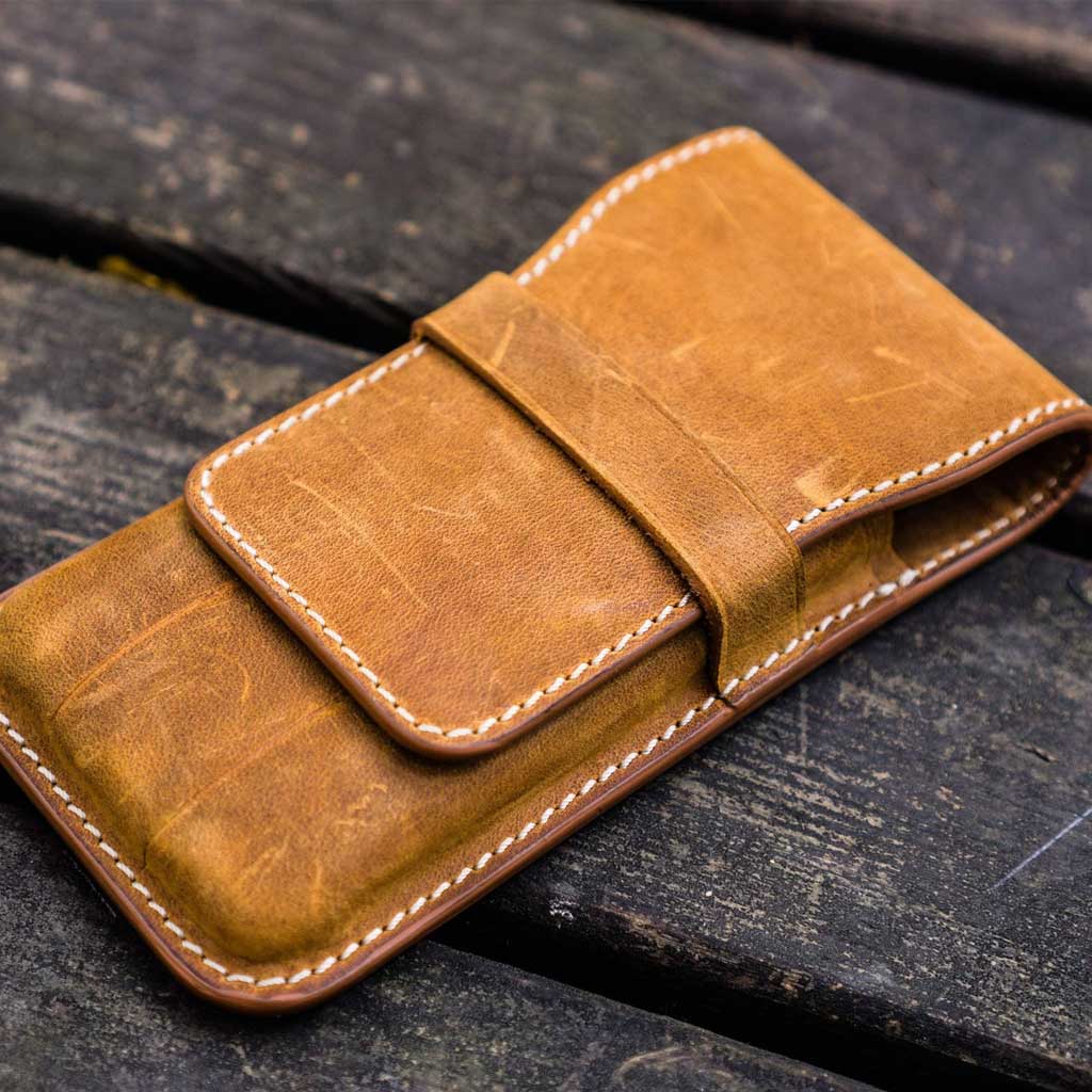 Crazy horse brown leather pen case on wooden background