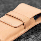 Undyed natural leather pen case on wooden surface