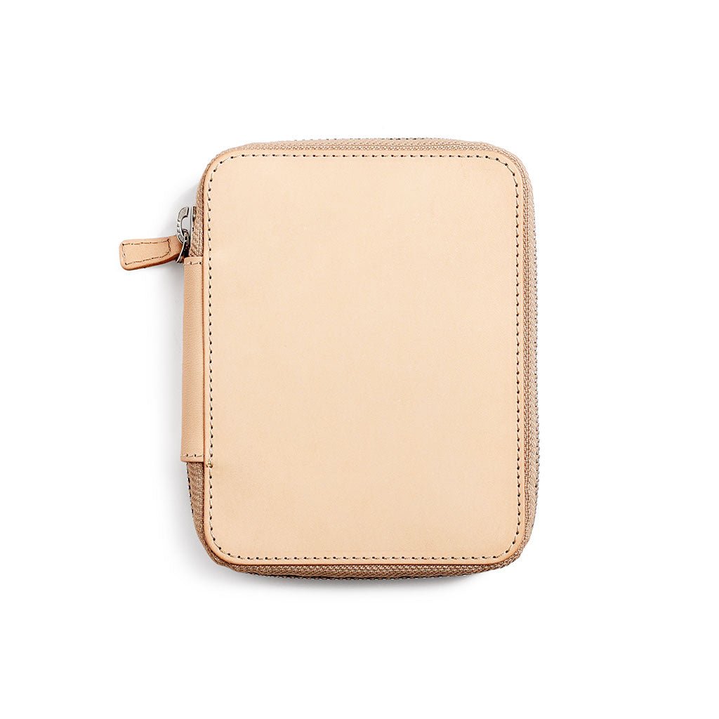 Natural undyed leather zippered pen case on a white background
