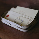 A metal tray holds letterpress book labels and other ephemera
