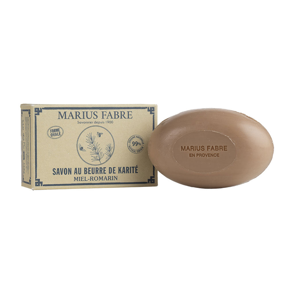 An oval-shaped bar of soap next to a branded paper box.