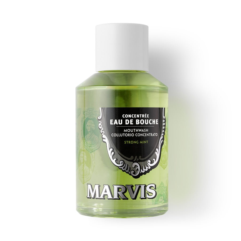 A bottle of Marvis mouthwash concentrate laying on white background.