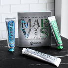 Marvis Toothpaste trio set on black counter.