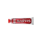 Red cinnamon mint marvis toothpaste tube on white background