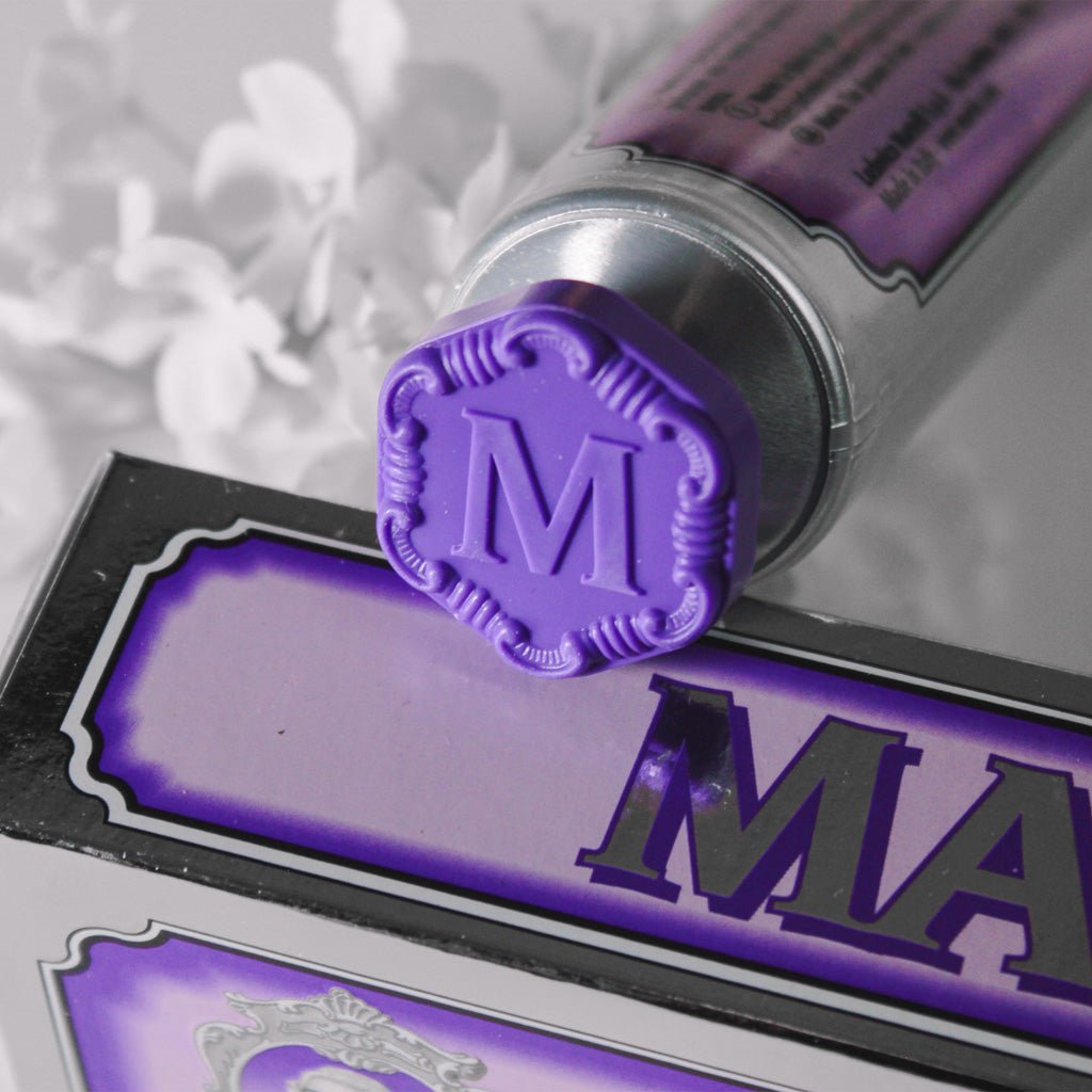 Close-up of purple Marvis toothpaste tube cap on top of packaging.