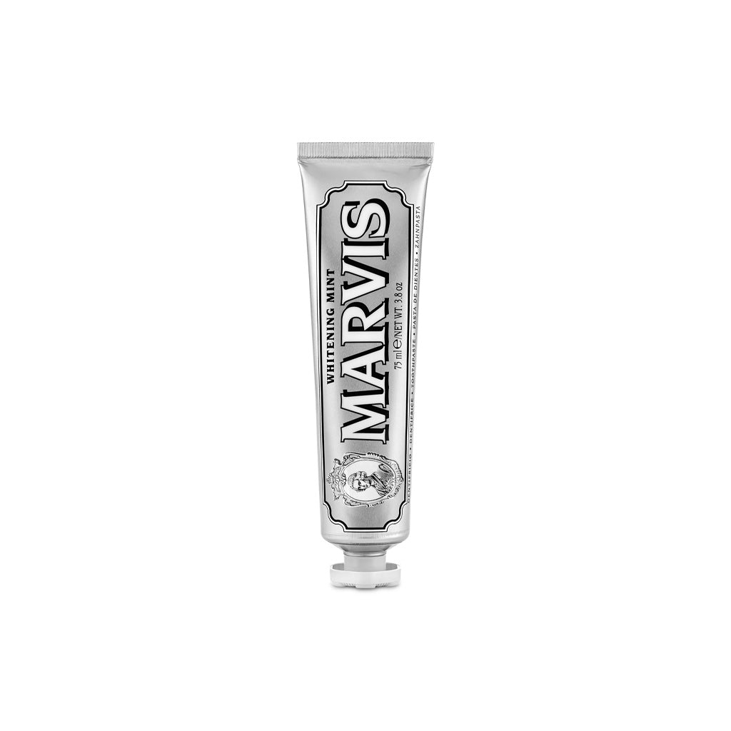 A silver tube of Whitening Mint Marvis toothpaste standing upright.
