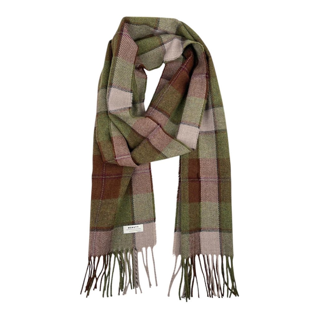 A plaid scarf with fringe arranged in a loop.