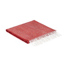 A folded red woven scarf with white fringe, displayed on a clean white background.