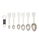 Set of six silver measuring spoons with decorative handles on a white background