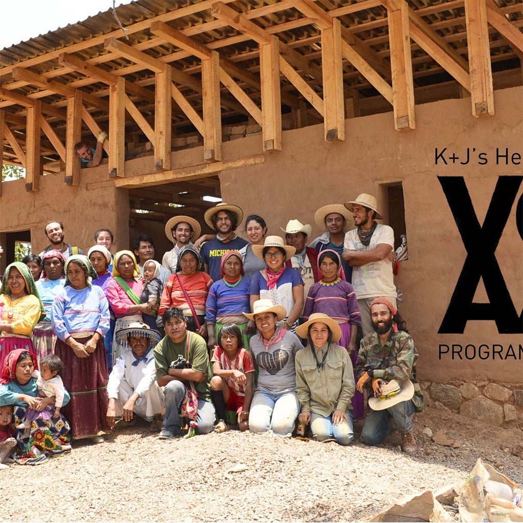 Group of people posing in front of a partially built structure
