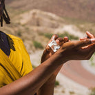 Person rolling perfume on their wrist 
