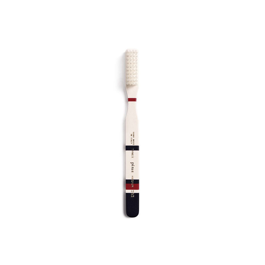 Midnight blue and cream toothbrush on white background