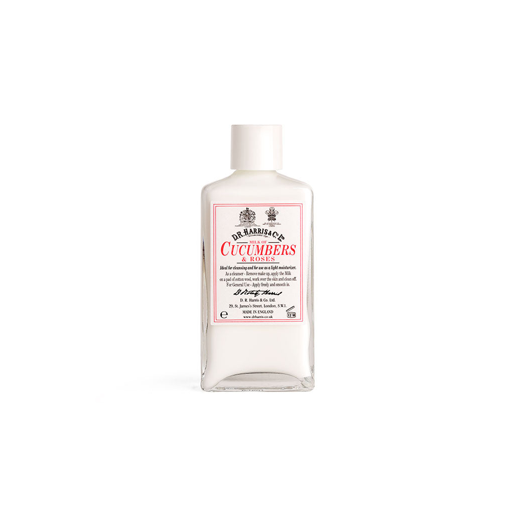 Bottle of D. R. Harris milk of cucumber and roses with white cap on white background
