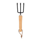 Gardening tool with black metal prongs and wooden handle on a white background