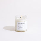 Candle with 'Montana Forest' label on a white background