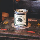 Candle of 'Night in the Woods' by Bradley Mountain on a rustic surface