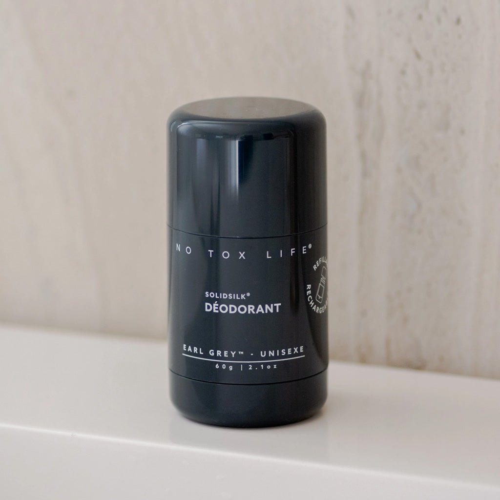 Black Earl Grey deodorant tube closed on bathroom shelf. 