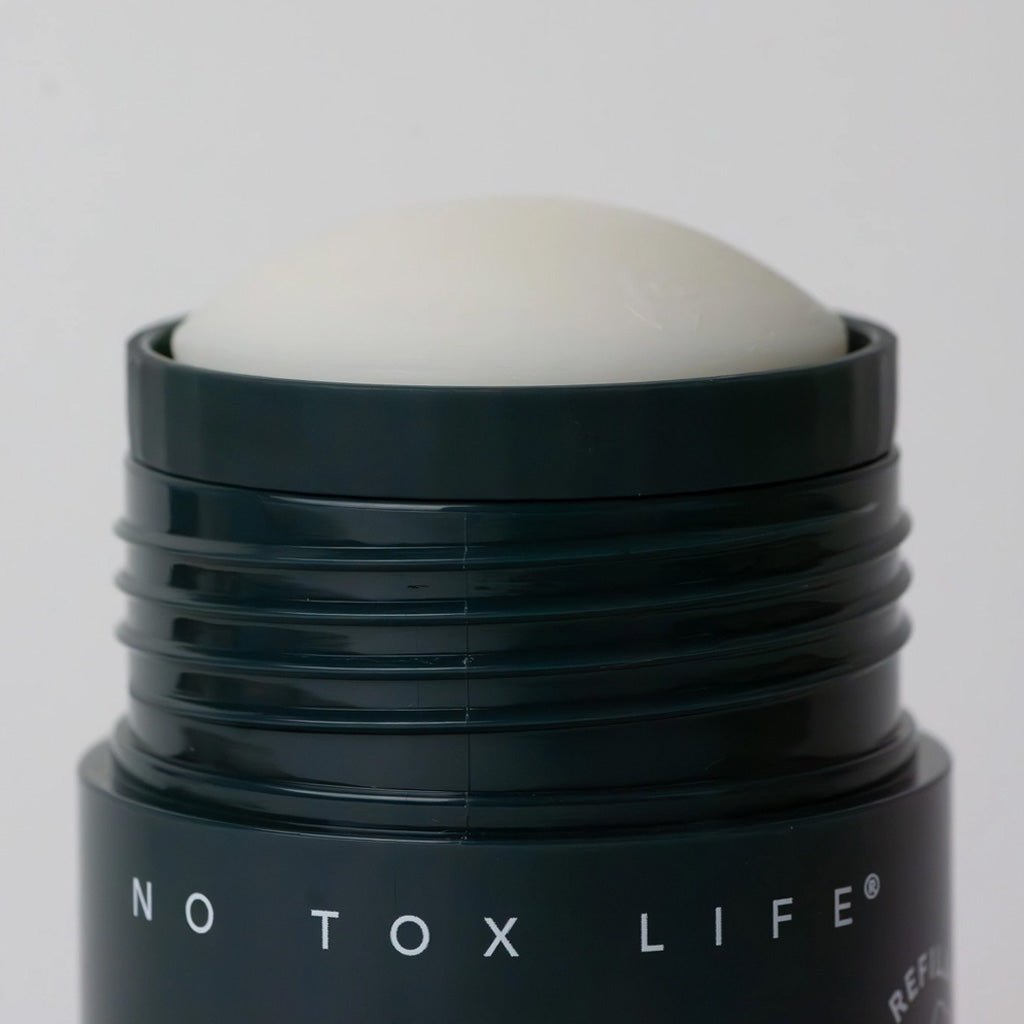 Black Earl Grey deodorant tube open with deodorant half up. 