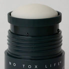 Black Earl Grey deodorant tube open with deodorant pushed all the way up. 