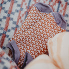 Pink and orange patterned wool socks with purple accents.